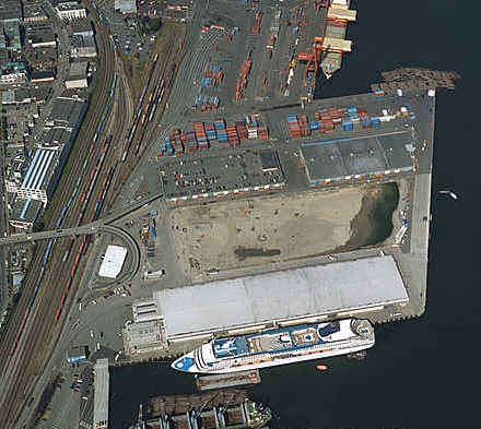 The Norwegian Wind docked at Ballantyne Pier.  Floating Logs to be loaded on ships (like ship in the lower part of the picture) visible in picture.  Barge adjacent to cruise ship is for unloading refuse.